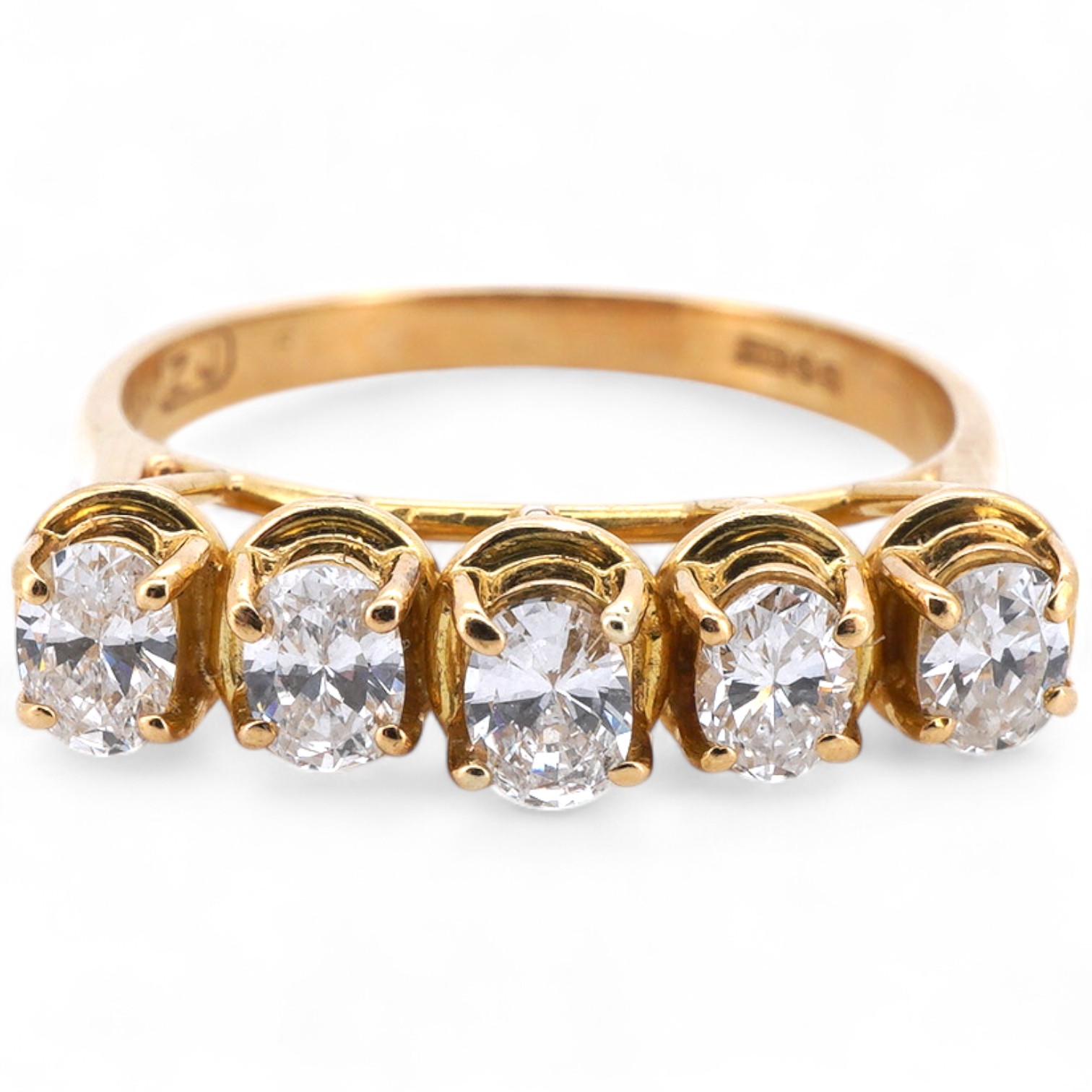A five-stone diamond ring, claw-set with five oval diamonds totalling approximately 0.40 carats, mounted in gold, size M1/2, stamped 18K, gross weight approximately 3.5 grams